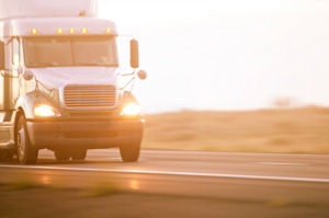 Truck driving in the sunset